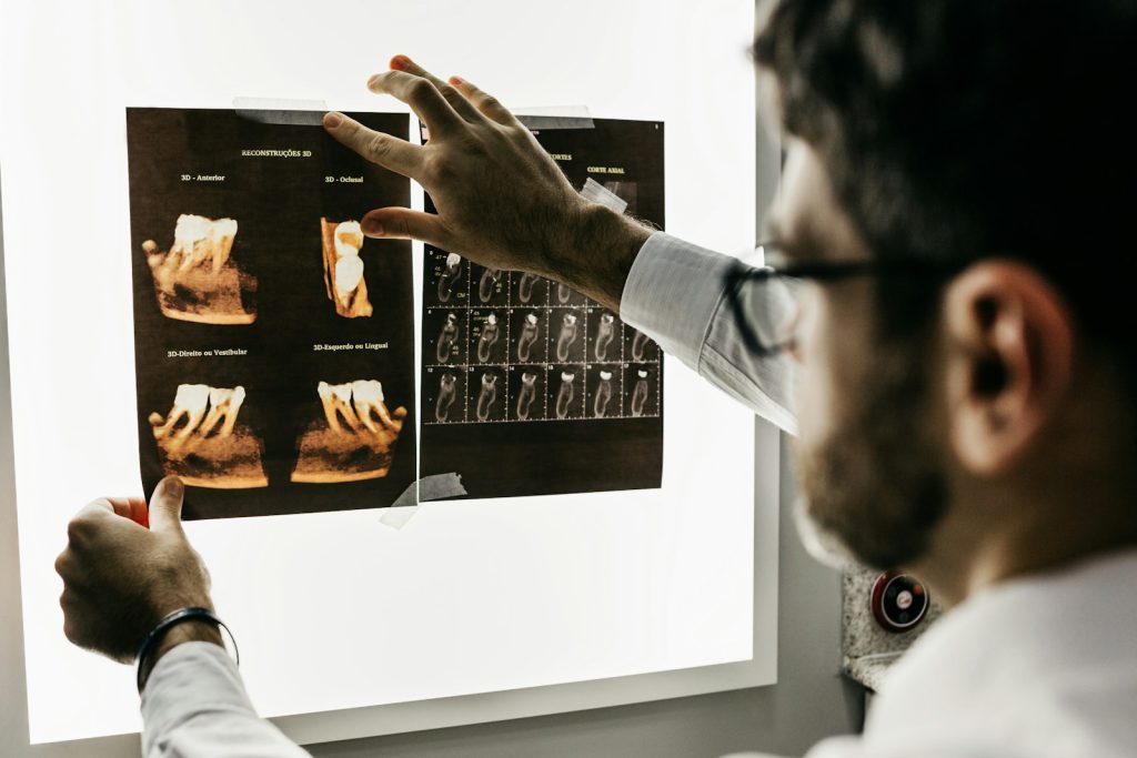A doctor reviewing medical imaging on a lightbox
