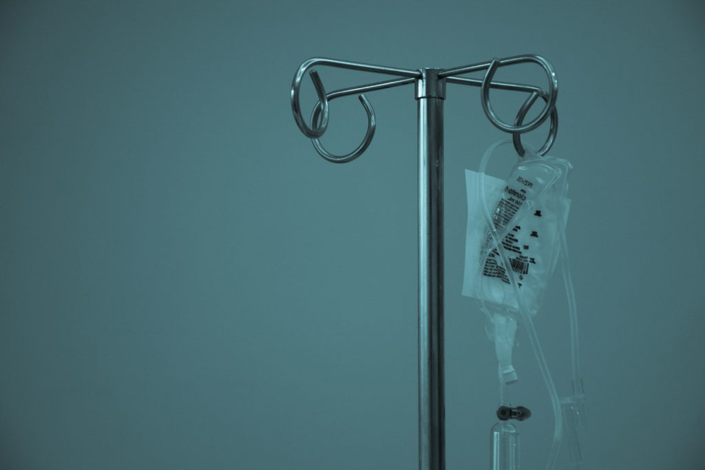 An intravenous drip stand in a hospital room